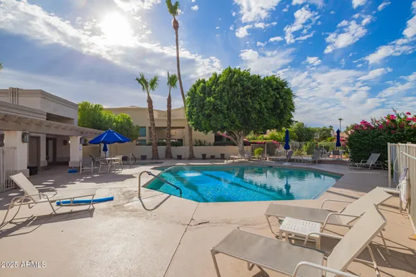 a view of swimming pool with outdoor seating