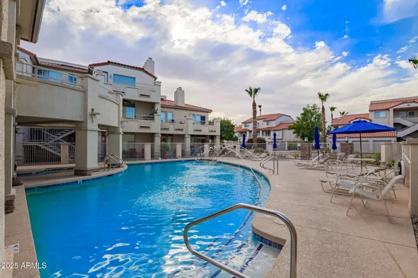a view of a swimming pool with outdoor seating
