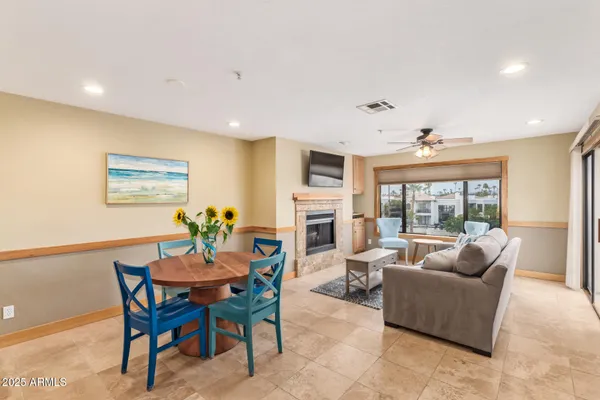 a living room with fireplace furniture and a large window