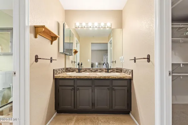 a bathroom with a double vanity sink and mirror