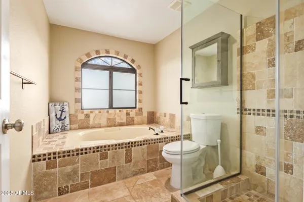 a bathroom with a bathtub toilet and shower