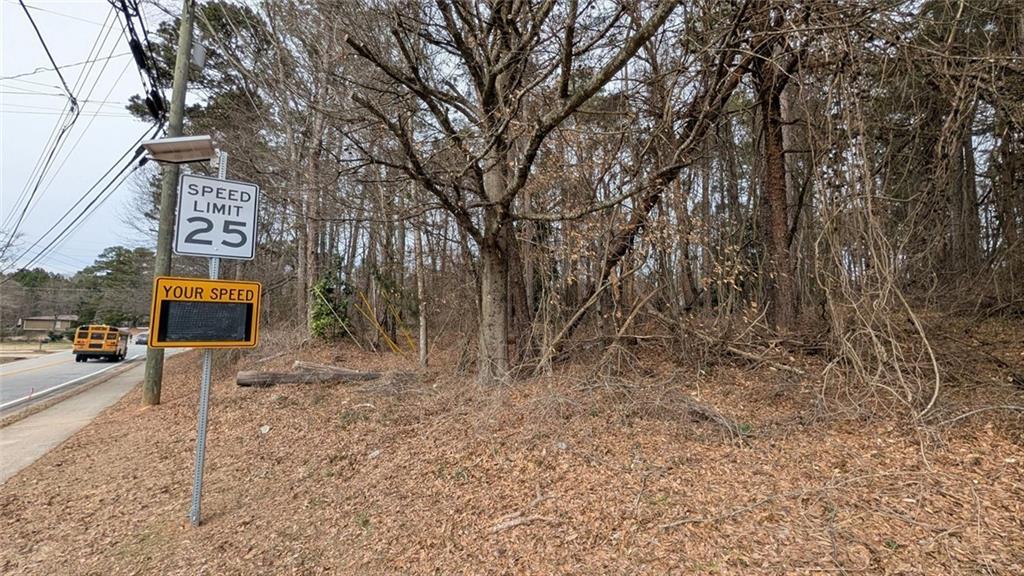 5305 Sycamore Road Sugar Hill, GA 30518 - Photo 3 of 18 a backyard of a house with lots of green space and chair