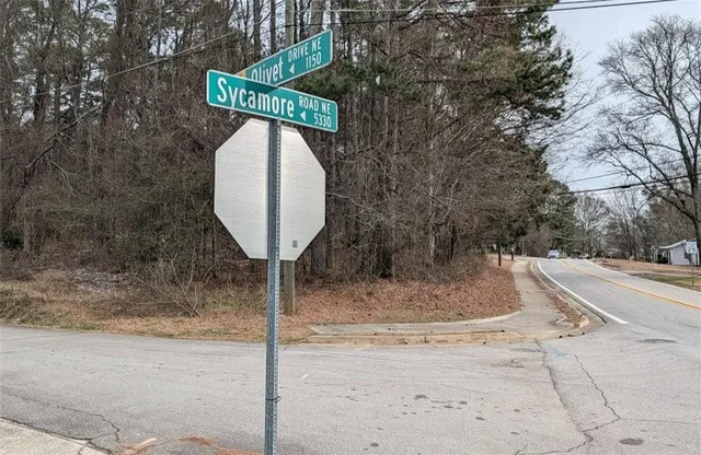 a view of a swimming pool with a patio and a yard