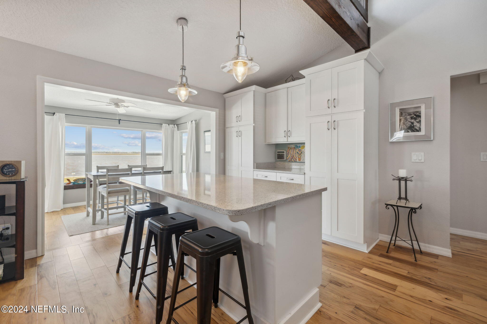 16045 Shellcracker Road Jacksonville, FL 32226 - Photo 14 of 40 a kitchen with stainless steel appliances kitchen island granite countertop a dining table chairs and white cabinets
