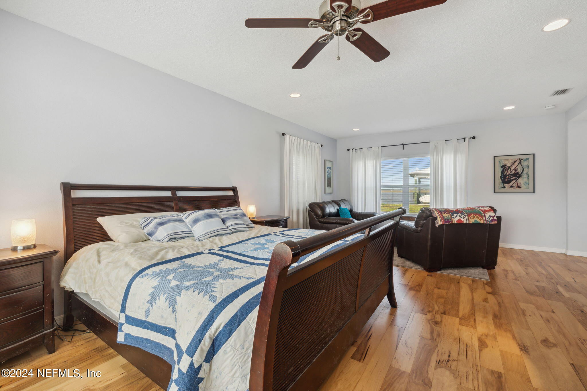 16045 Shellcracker Road Jacksonville, FL 32226 - Photo 16 of 40 a bed room with a bed and a chandelier