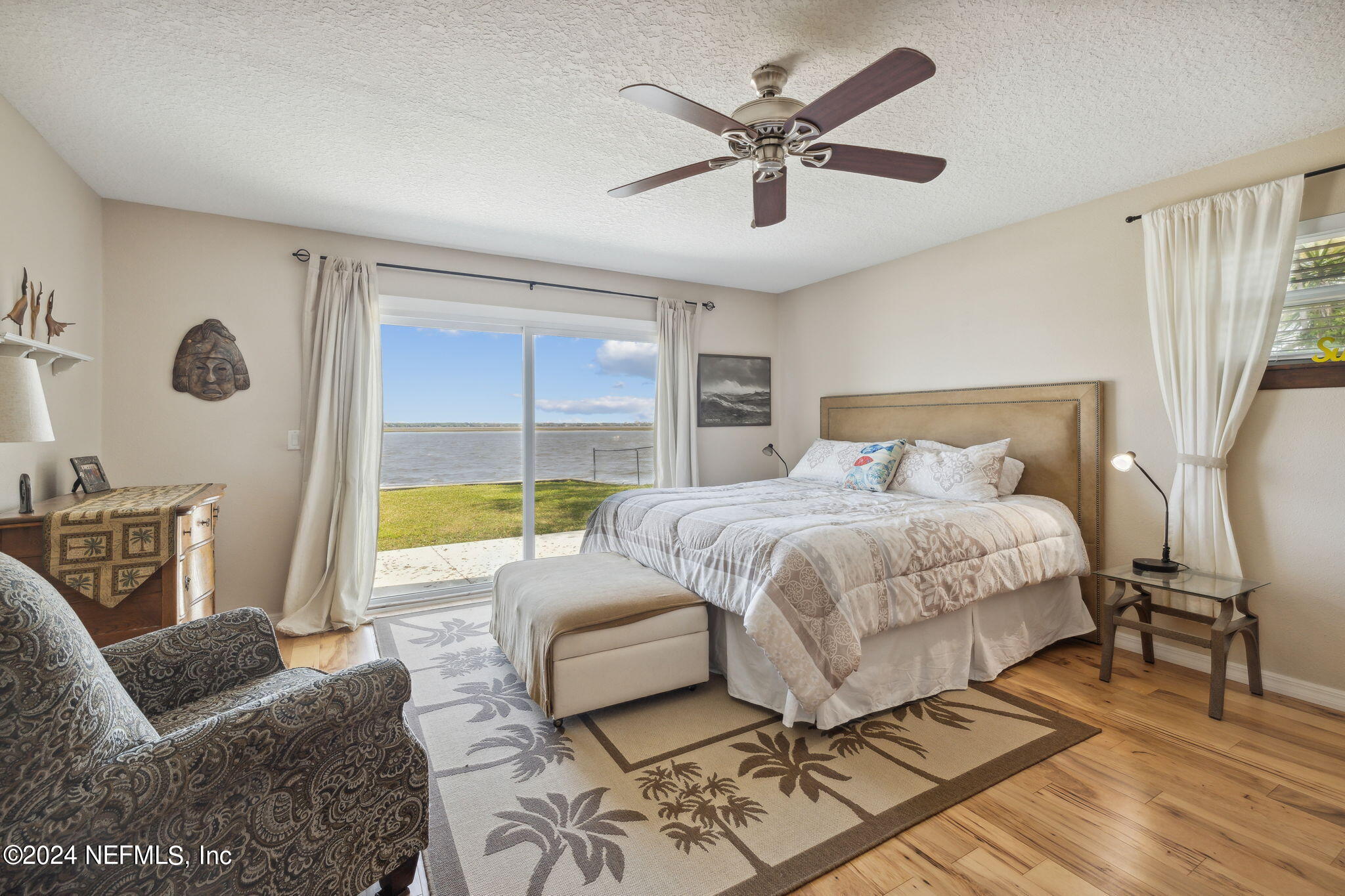 16045 Shellcracker Road Jacksonville, FL 32226 - Photo 20 of 40 a spacious bedroom with a bed a couch and a window