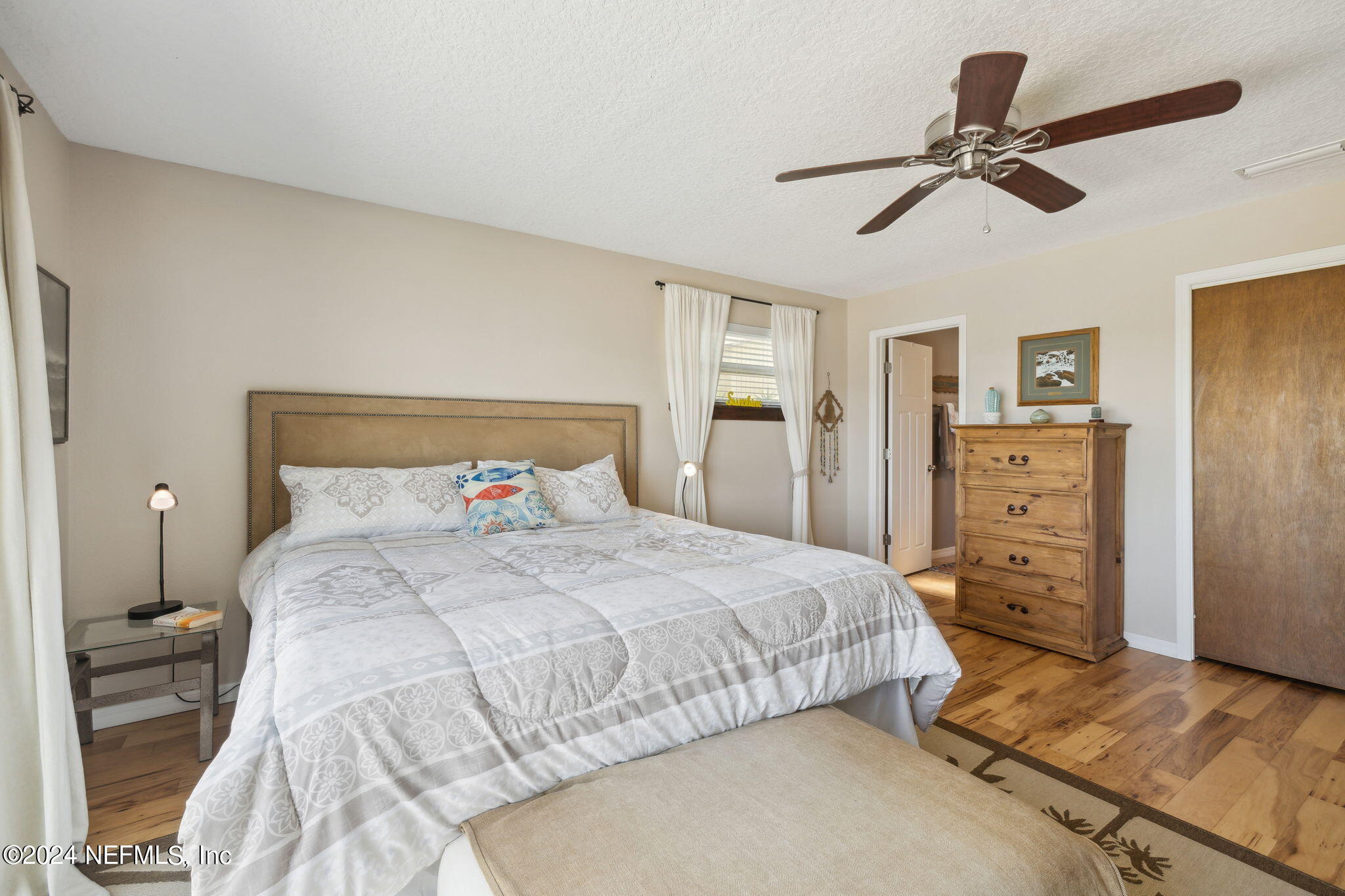 16045 Shellcracker Road Jacksonville, FL 32226 - Photo 21 of 40 a bedroom with a bed and a chandelier