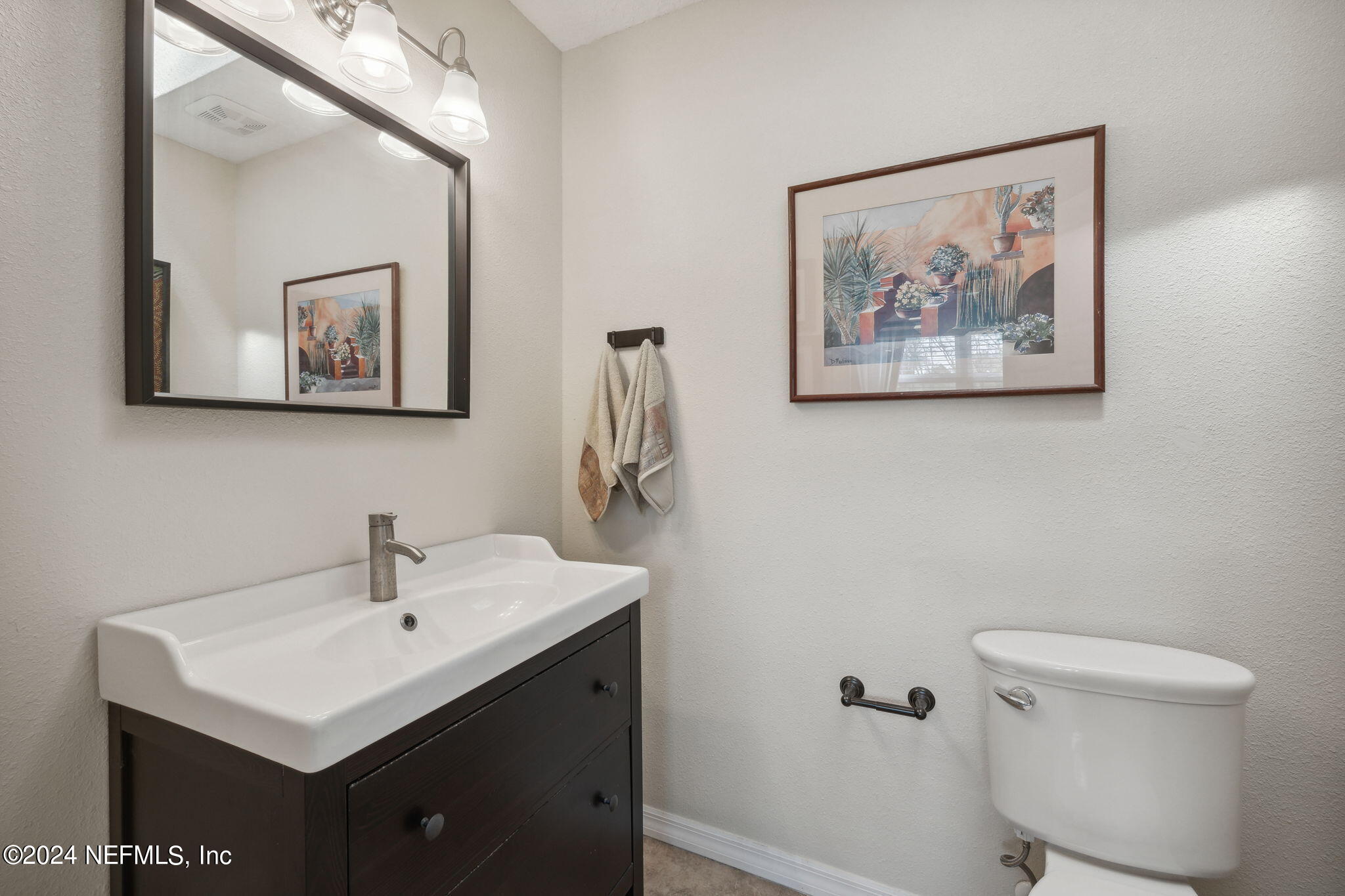 16045 Shellcracker Road Jacksonville, FL 32226 - Photo 26 of 40 a bathroom with a toilet sink and mirror