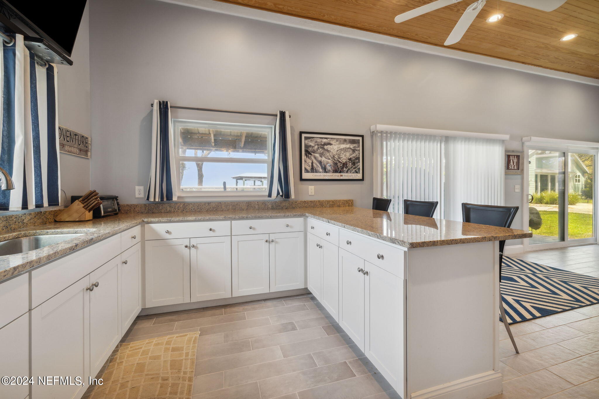 16045 Shellcracker Road Jacksonville, FL 32226 - Photo 31 of 40 a large white kitchen with a stove a sink a window and a granite counter top