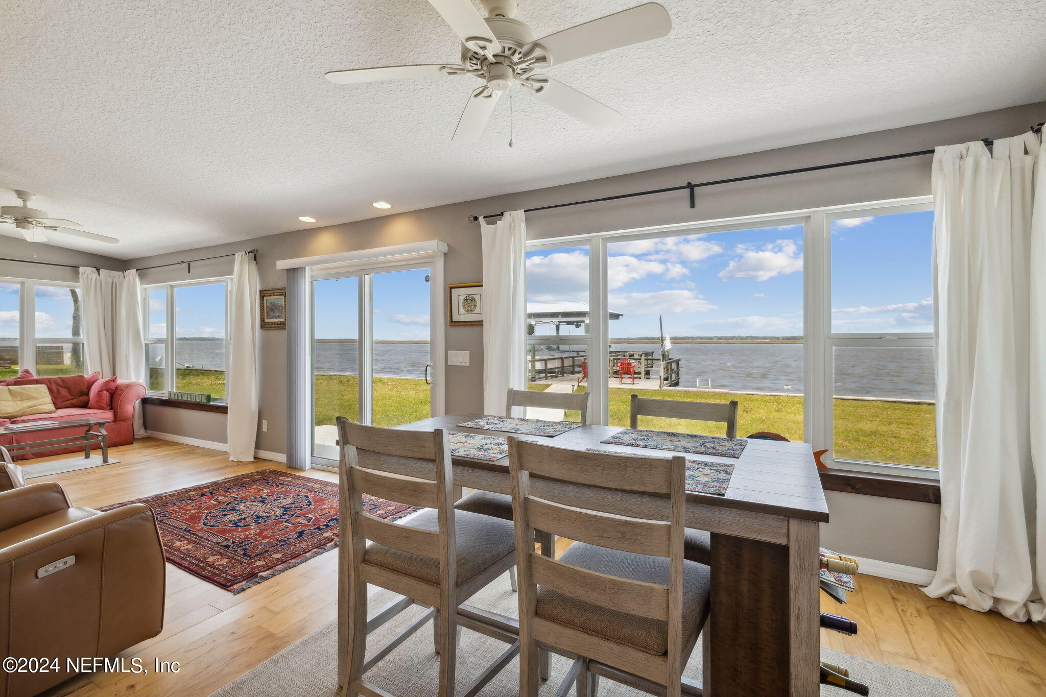 16045 Shellcracker Road Jacksonville, FL 32226 - Photo 6 of 40 a living room with furniture and floor to ceiling windows