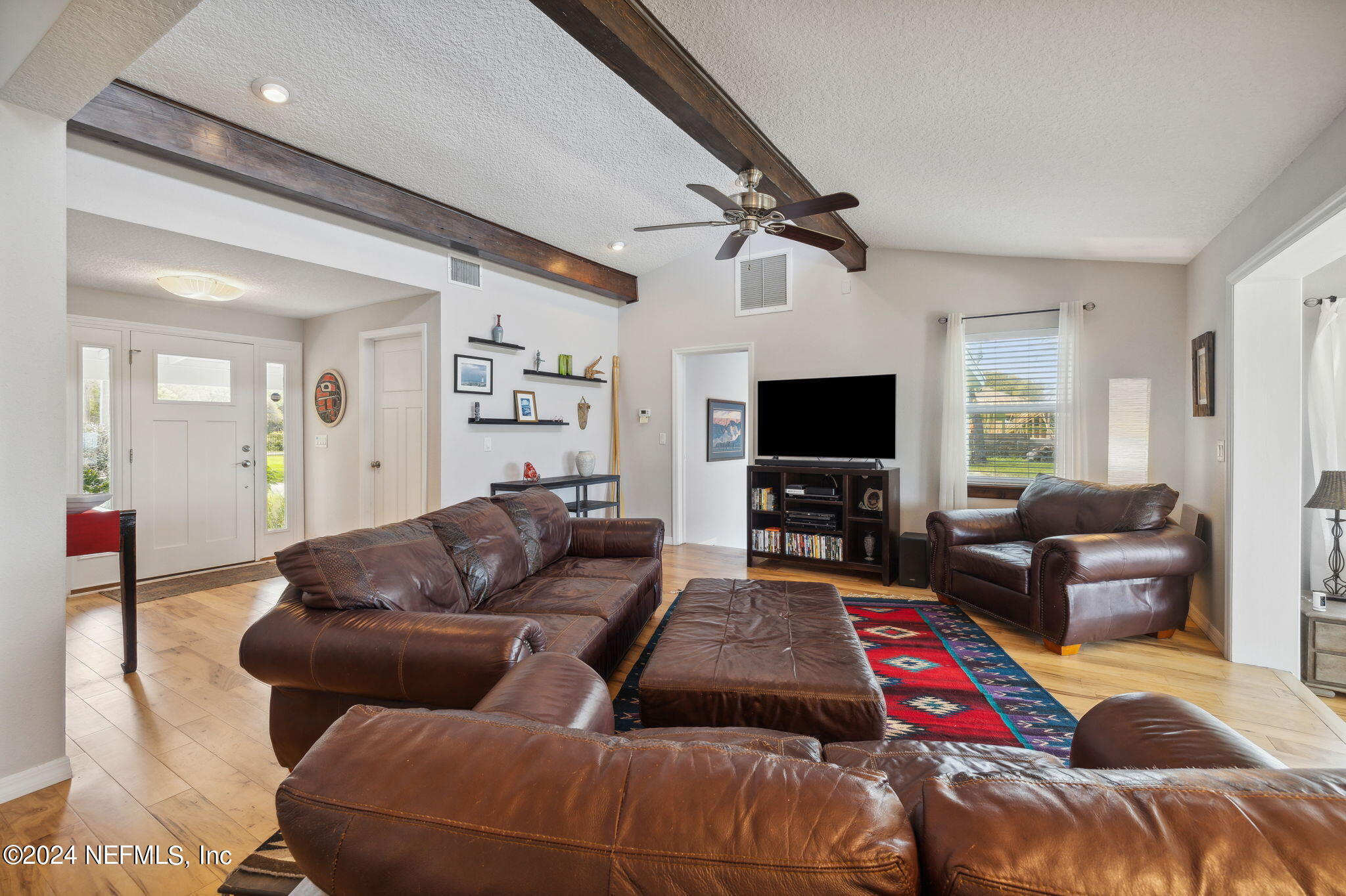 16045 Shellcracker Road Jacksonville, FL 32226 - Photo 8 of 40 a living room with furniture and a flat screen tv