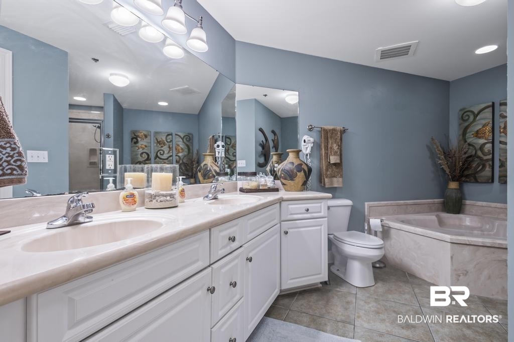 27582 Canal Road, Unit 2408 Orange Beach, AL 36561 - Photo 23 of 47 Bathroom featuring double vanity, a tub, toilet, and tile patterned flooring