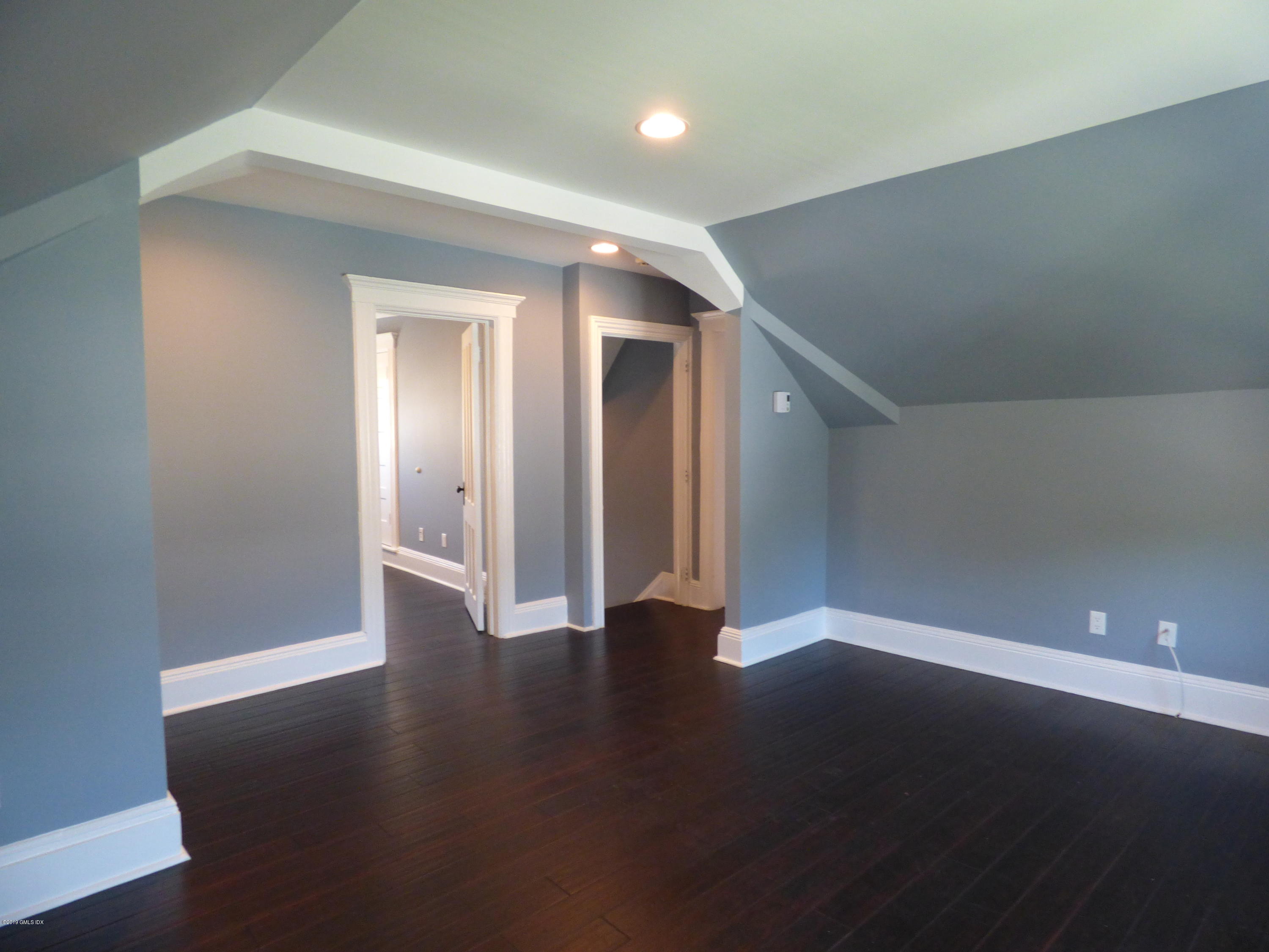 16 Lexington Avenue, Unit UPSTAIRS Greenwich, CT 06830 - Photo 7 of 12 a view of an empty room with wooden floor