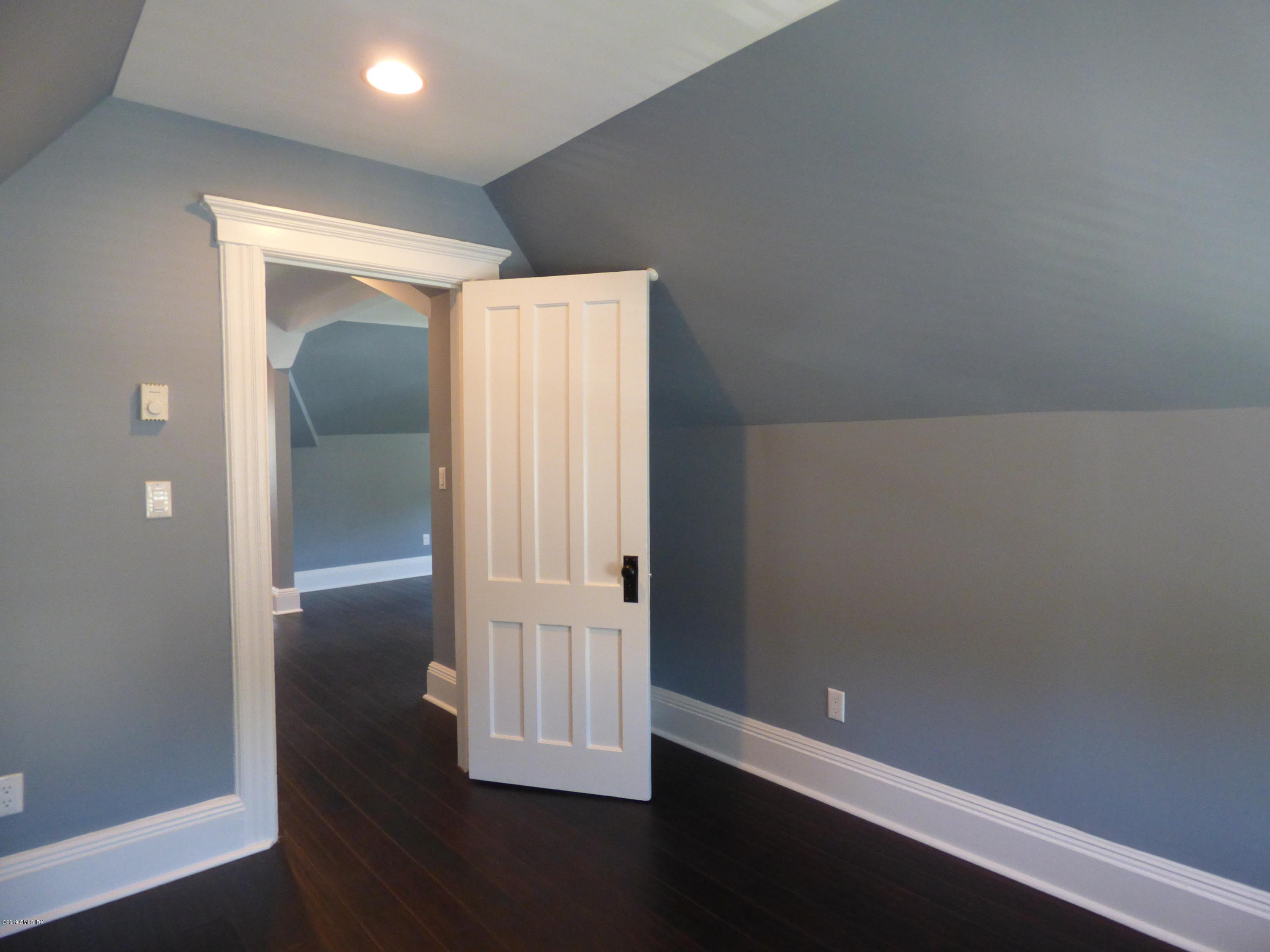 16 Lexington Avenue, Unit UPSTAIRS Greenwich, CT 06830 - Photo 9 of 12 an empty room with wooden floor & closet and windows
