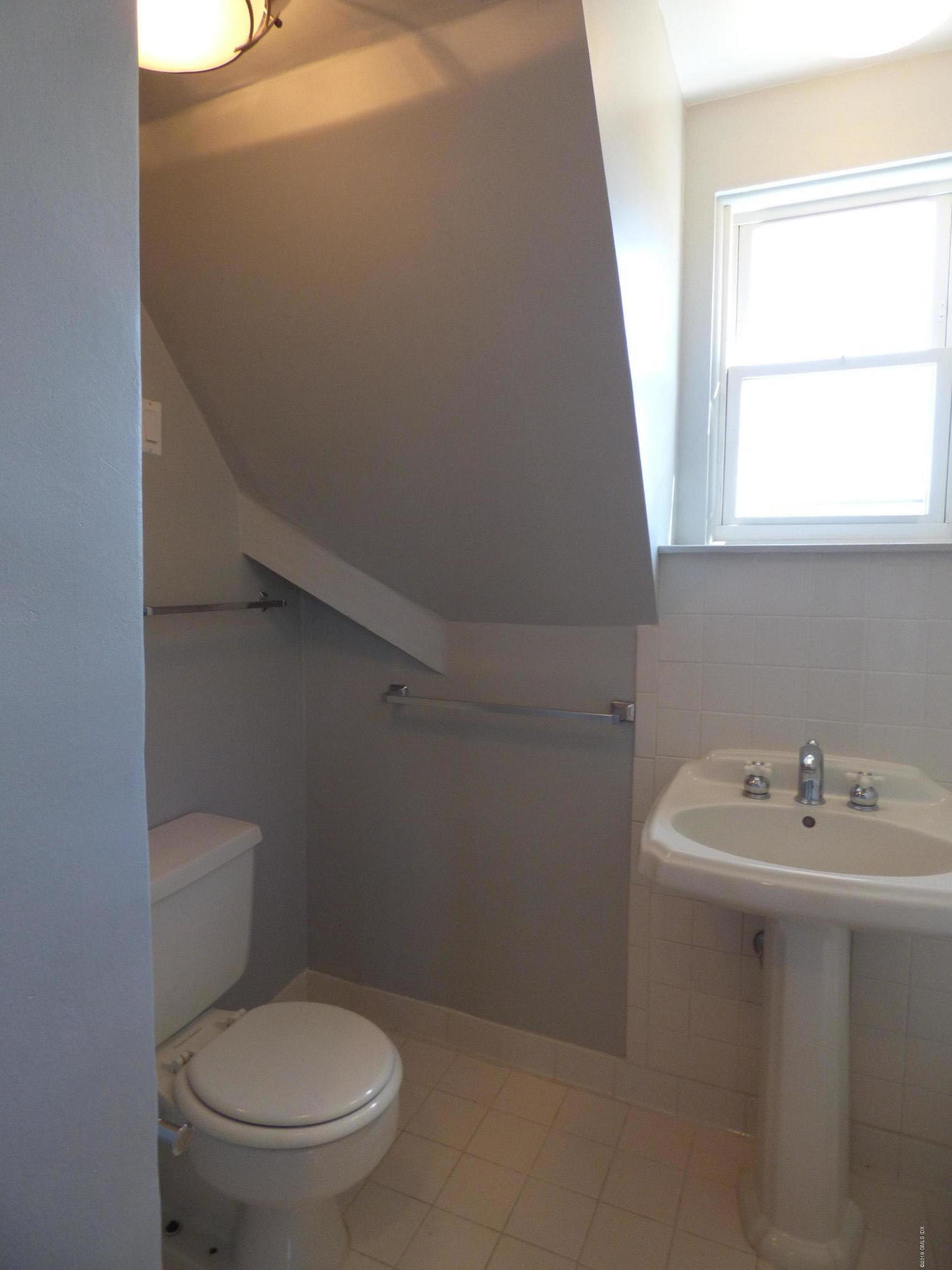 16 Lexington Avenue, Unit UPSTAIRS Greenwich, CT 06830 - Photo 10 of 12 a bathroom with a sink a toilet and a window