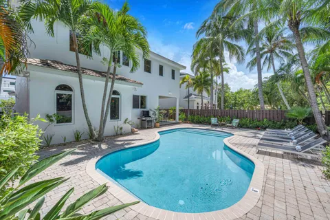 a view of a swimming pool with a house