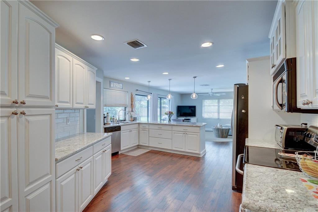 1139 Northwest Fork Road Stuart, FL 34994 - Photo 12 of 43 a large kitchen with stainless steel appliances sink a microwave and cabinets