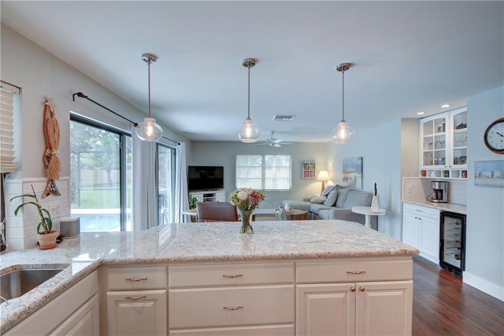 1139 Northwest Fork Road Stuart, FL 34994 - Photo 14 of 43 a kitchen with counter top space a sink appliances and cabinets