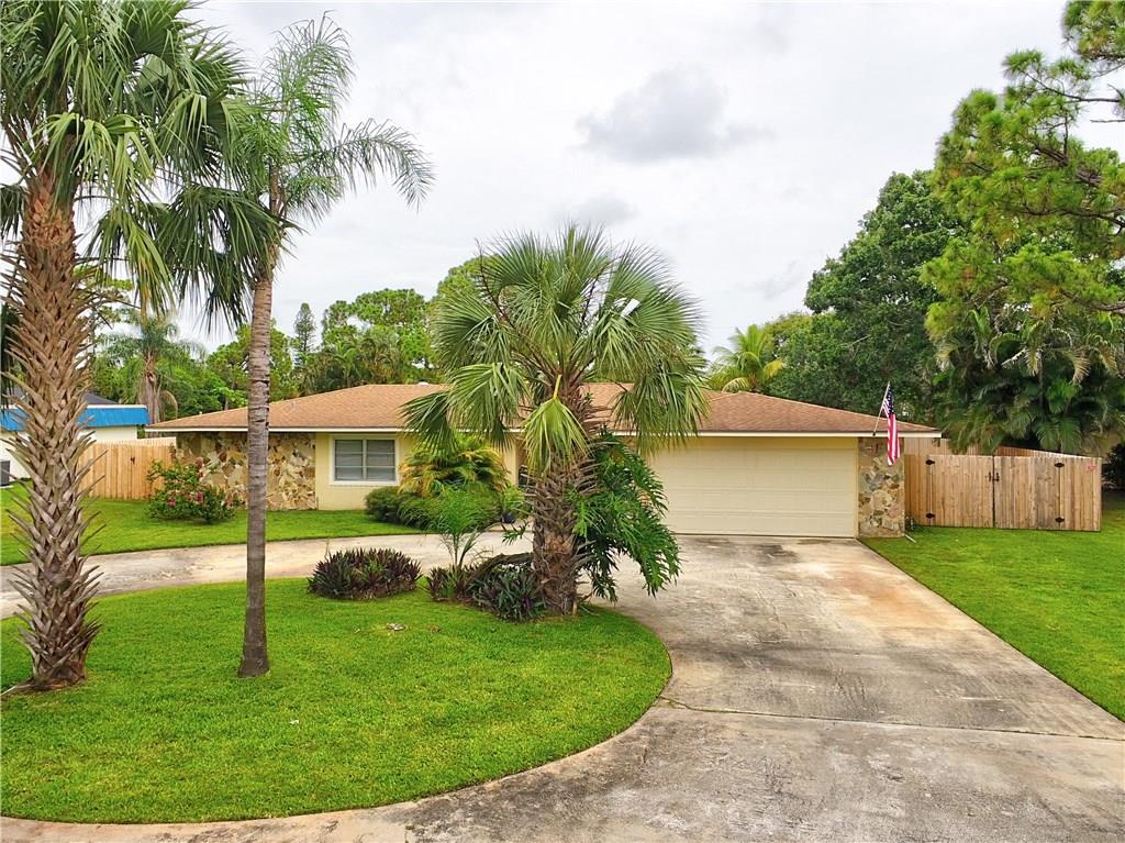1139 Northwest Fork Road Stuart, FL 34994 - Photo 2 of 43 front view of a house with a yard