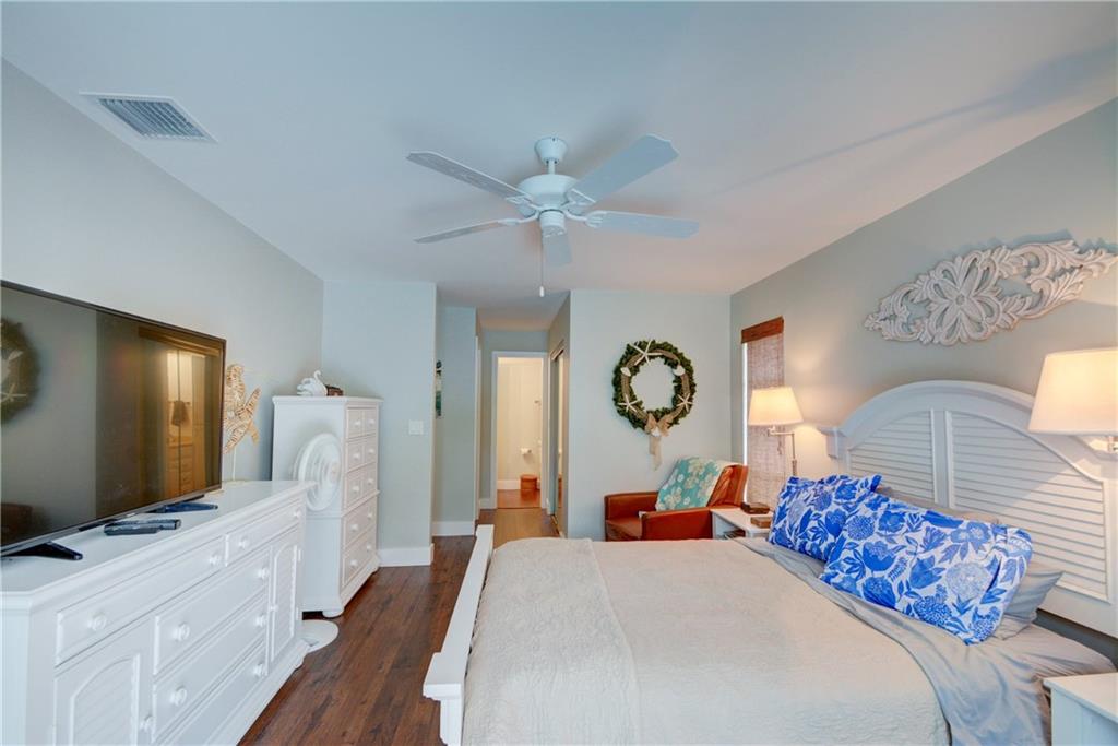 1139 Northwest Fork Road Stuart, FL 34994 - Photo 22 of 43 a bedroom with a bed and a flat screen tv