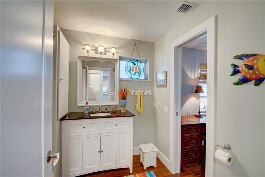 1139 Northwest Fork Road Stuart, FL 34994 - Photo 25 of 43 a bathroom with cabinets and a wooden floor