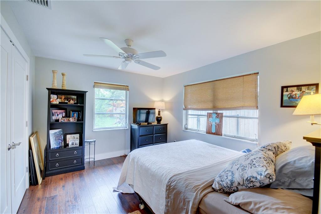 1139 Northwest Fork Road Stuart, FL 34994 - Photo 26 of 43 a bedroom with a bed a dresser and bookshelf