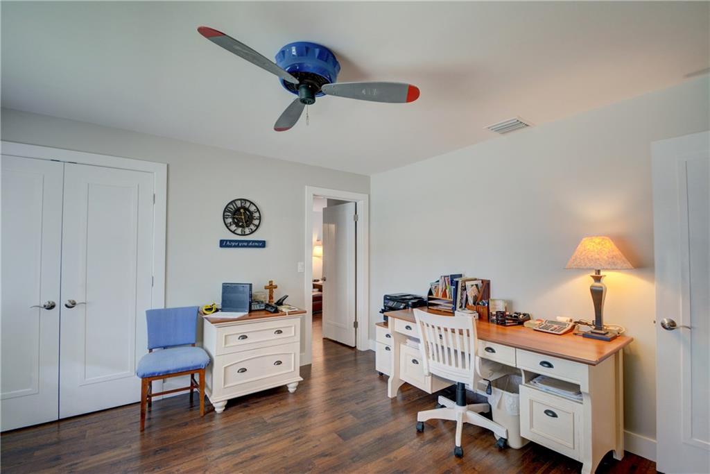 1139 Northwest Fork Road Stuart, FL 34994 - Photo 27 of 43 a view of a workspace with furniture and wooden floor