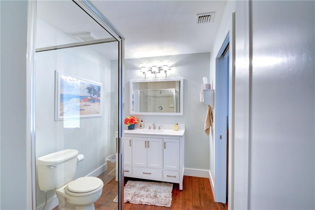 1139 Northwest Fork Road Stuart, FL 34994 - Photo 29 of 43 a spacious bathroom with a toilet sink and mirror