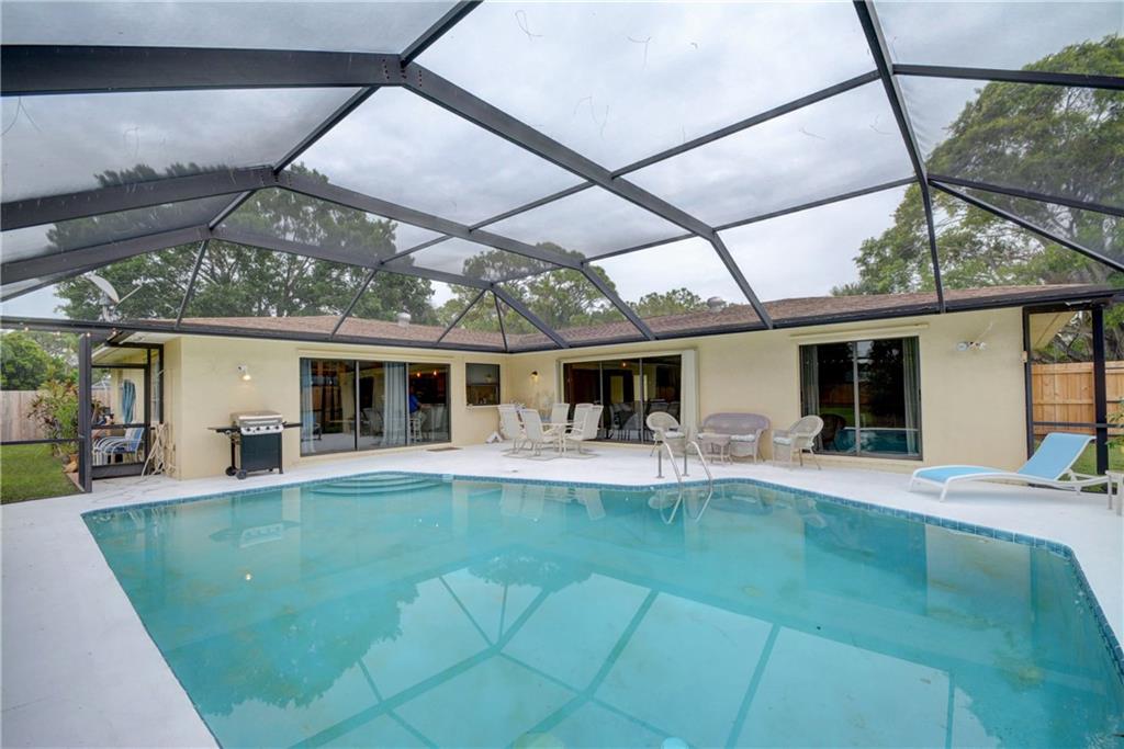 1139 Northwest Fork Road Stuart, FL 34994 - Photo 34 of 43 a view of a house with a backyard porch and sitting area