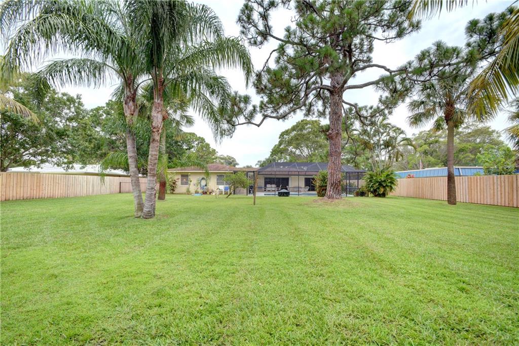 1139 Northwest Fork Road Stuart, FL 34994 - Photo 37 of 43 a view of a house with a big yard and palm trees