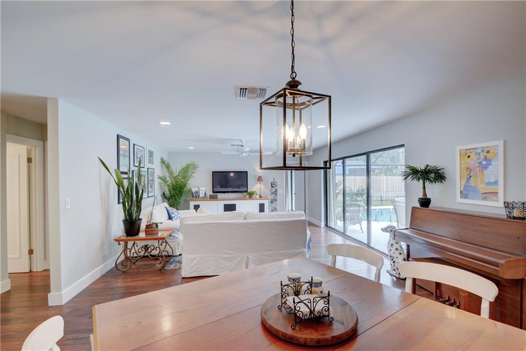 1139 Northwest Fork Road Stuart, FL 34994 - Photo 8 of 43 a living room with furniture kitchen view and a chandelier