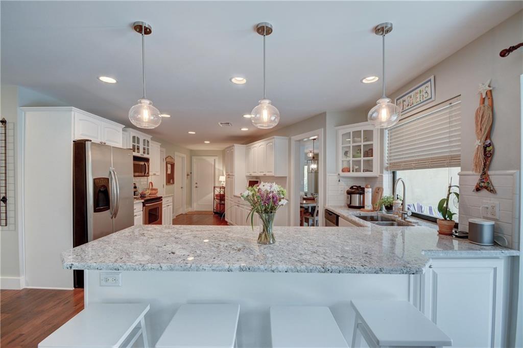 1139 Northwest Fork Road Stuart, FL 34994 - Photo 10 of 43 a kitchen with kitchen island a sink and a refrigerator