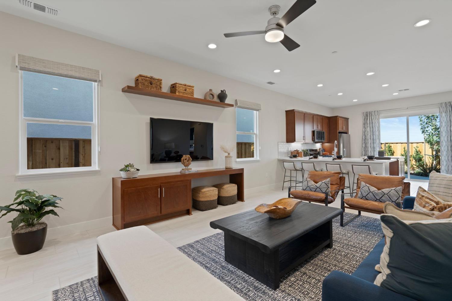 5542 Thomson Loop Davis, CA 95616 - Photo 7 of 63 a living room with furniture a flat screen tv and kitchen view