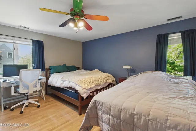 a bedroom with two beds and a chandelier