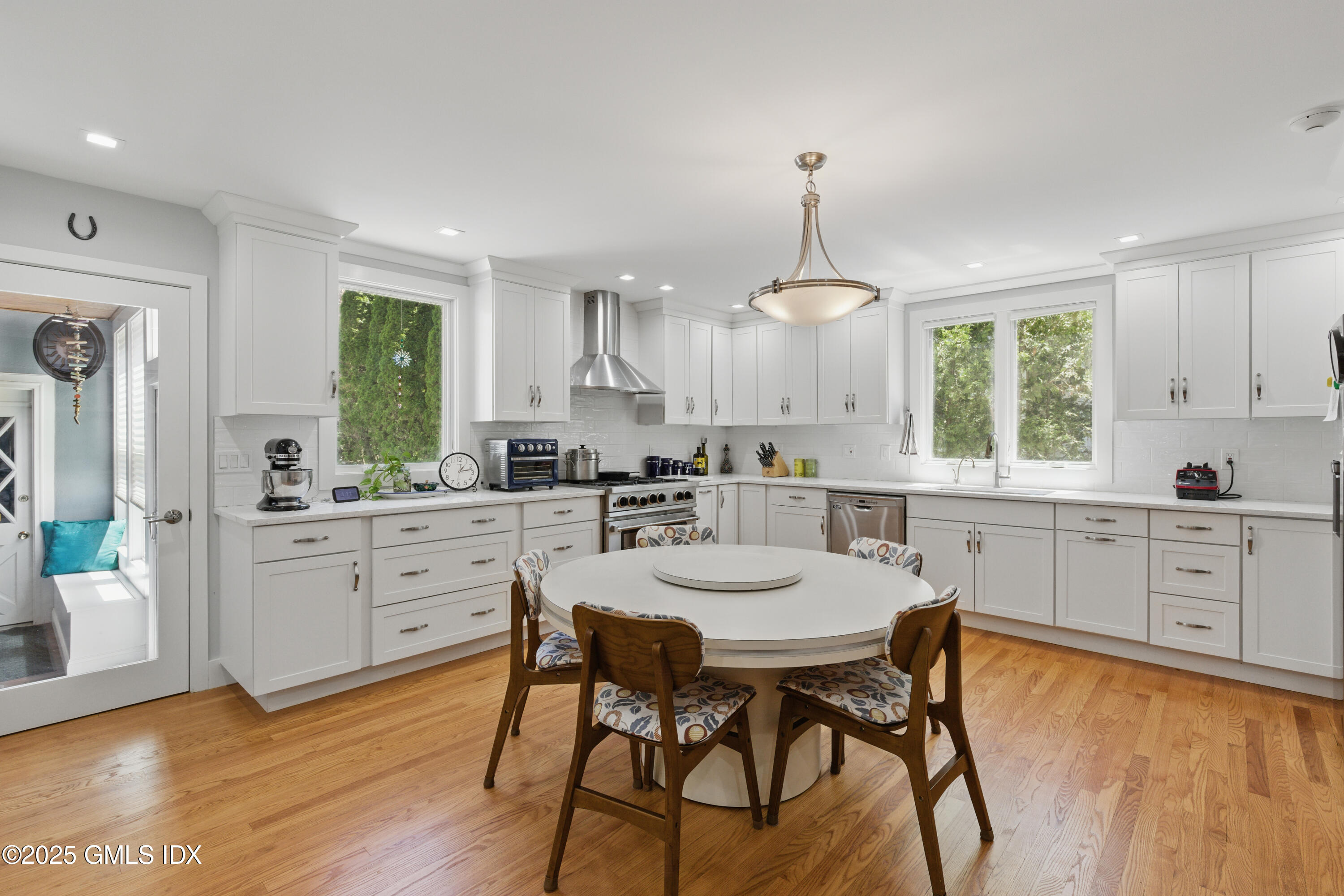 51 Orchard Place Greenwich, CT 06830 - Photo 6 of 18 a kitchen with sink a window and chairs