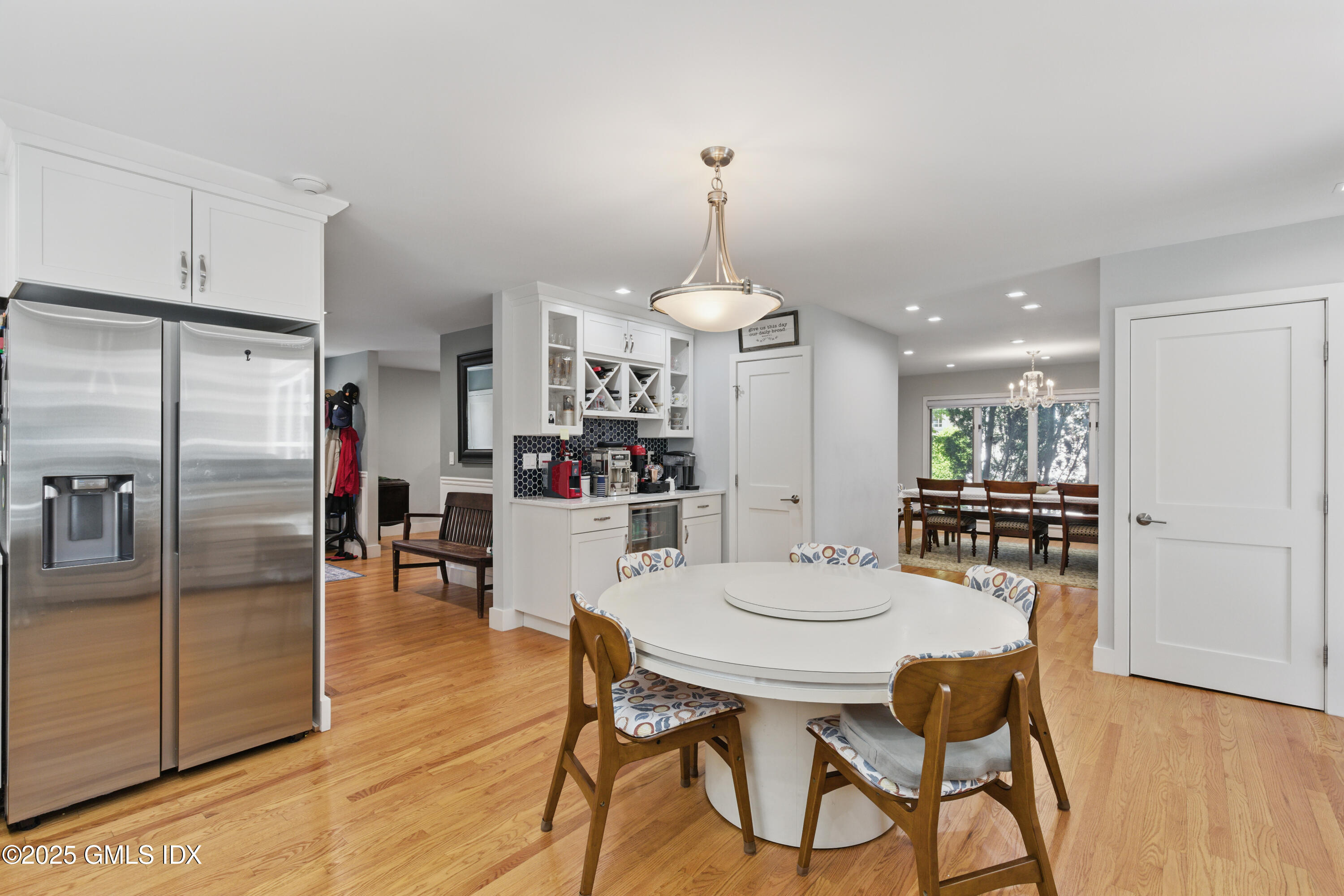 51 Orchard Place Greenwich, CT 06830 - Photo 7 of 18 a kitchen with stainless steel appliances kitchen island granite countertop a refrigerator a stove a kitchen island with a dining table and chairs