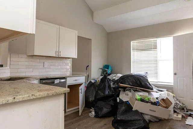 a kitchen with a sink a stove and a window