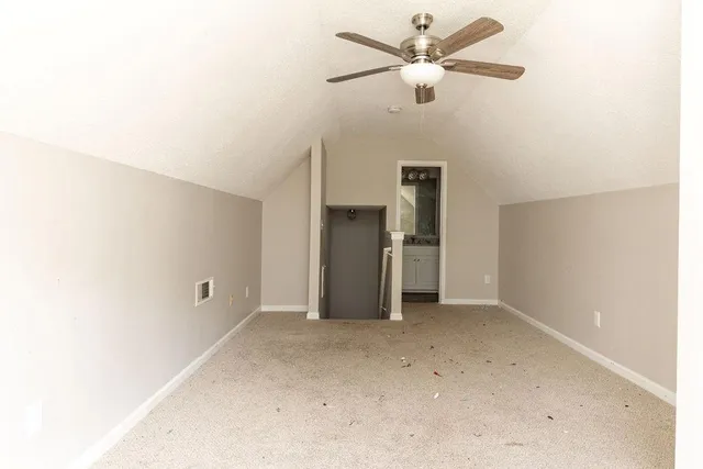 a view of a big room with a ceiling fan and a ceiling fan