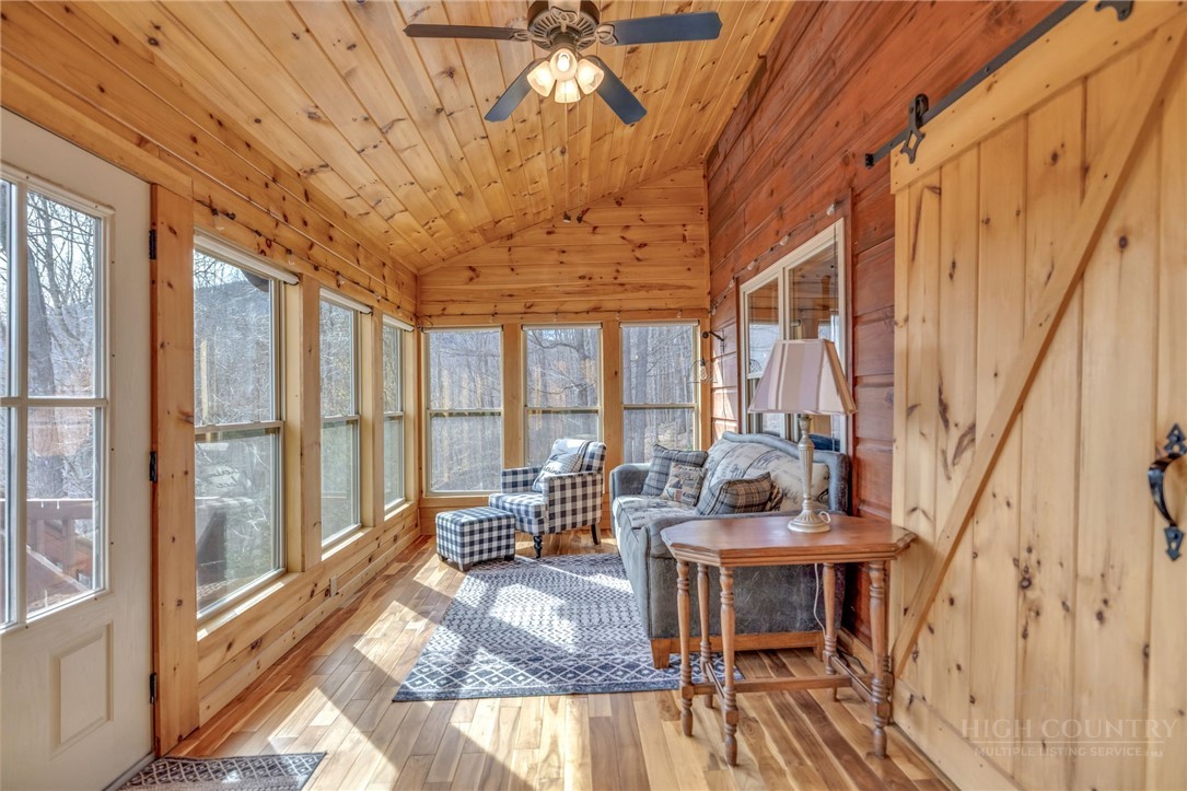7994 3 Top Road Todd, NC 28684 - Photo 14 of 50 a living room with furniture large windows and wooden floor