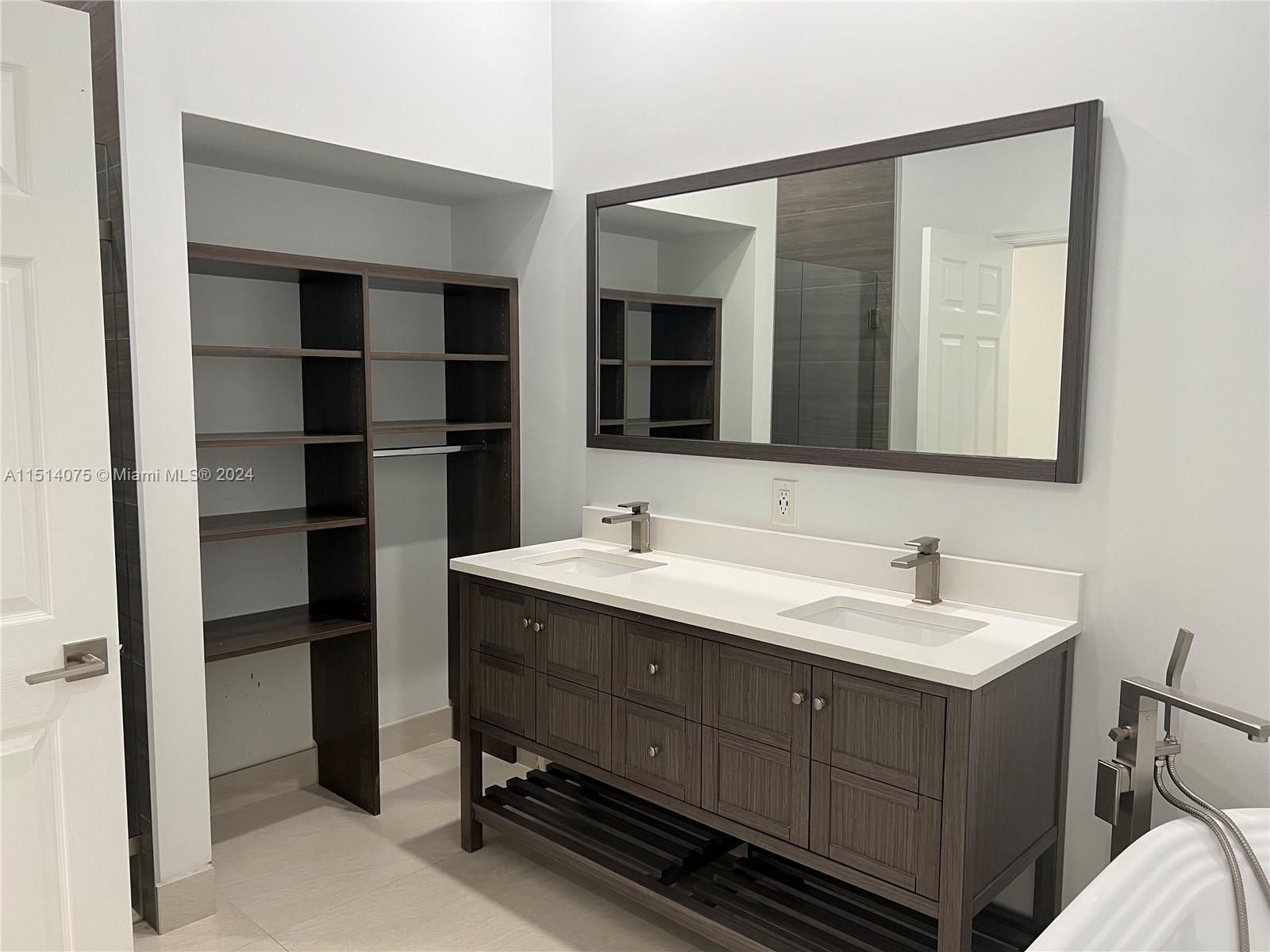 Savanna Weston, FL 33327 - Photo 11 of 26 a bathroom with a double vanity sink and a mirror