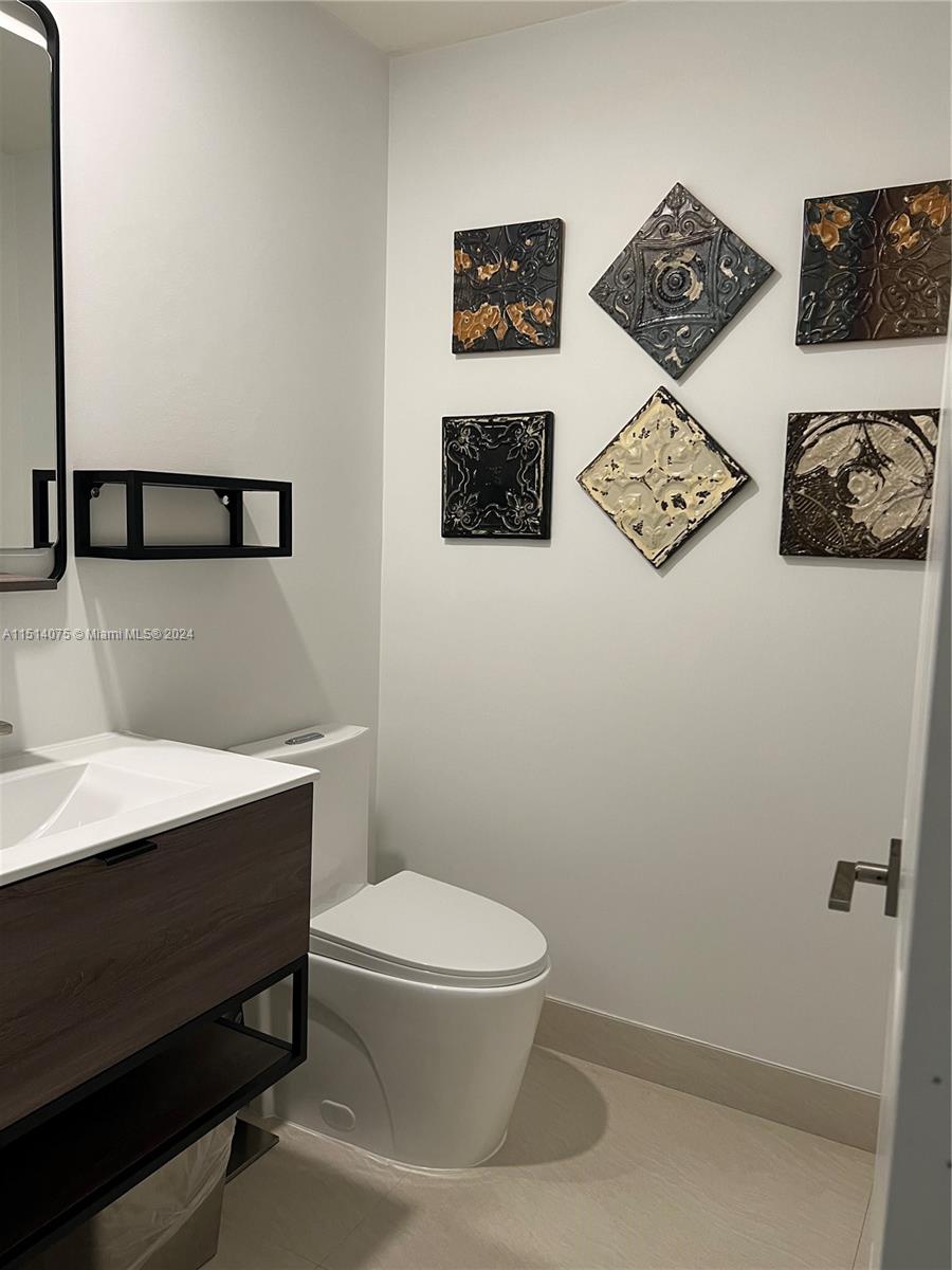 Savanna Weston, FL 33327 - Photo 14 of 26 a bathroom with a toilet a sink and vanity