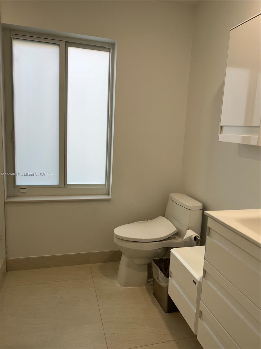 Savanna Weston, FL 33327 - Photo 17 of 26 a white toilet sitting next to a bathroom sink