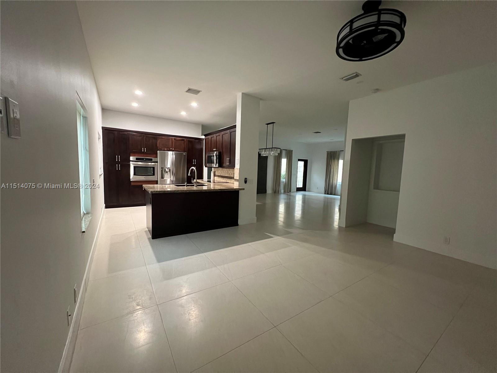 Savanna Weston, FL 33327 - Photo 6 of 26 a view of a kitchen with a sink and refrigerator in a kitchen