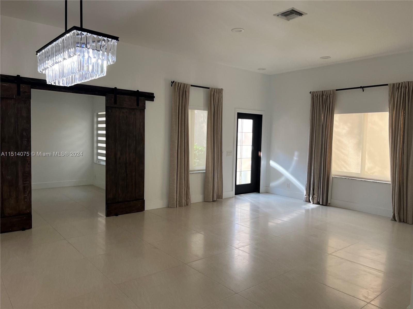 Savanna Weston, FL 33327 - Photo 7 of 26 a view of a livingroom with a chandelier fan and windows