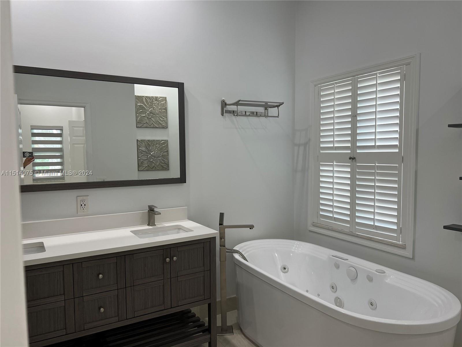 Savanna Weston, FL 33327 - Photo 10 of 26 a bathroom with a bathtub sink and mirror