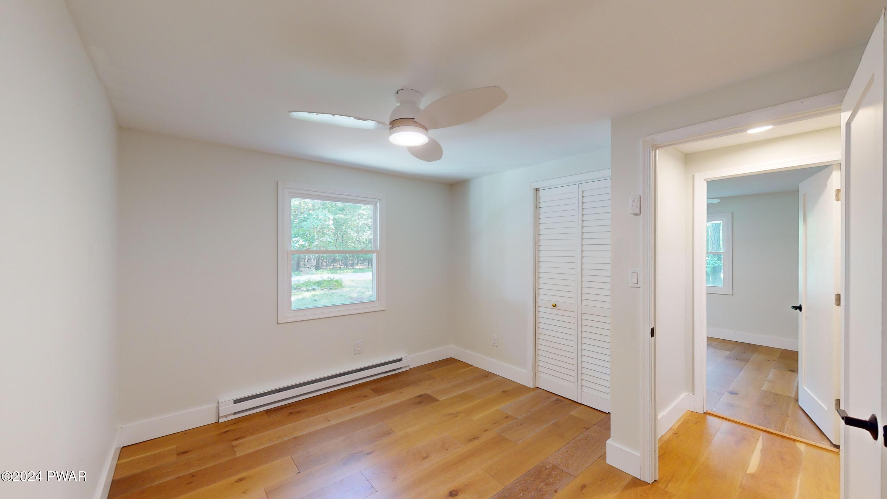 107 Hickory Road Milford, PA 18337 - Photo 39 of 39 a view of empty room with wooden floor and fan