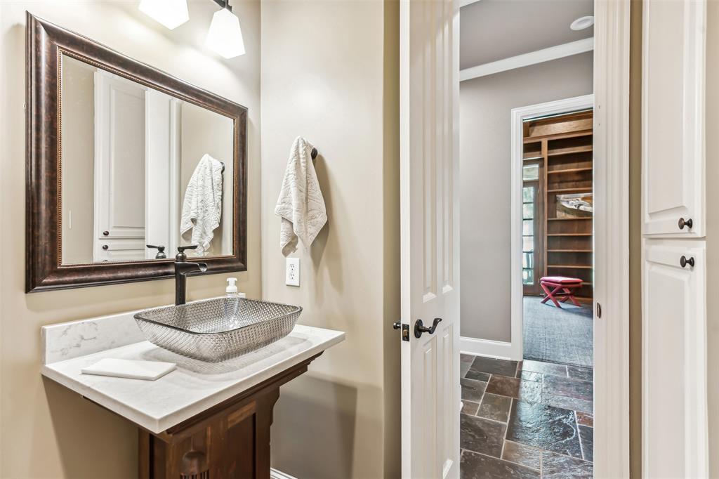 1815 West Forest Grove Road Lucas, TX 75002 - Photo 12 of 40 Bathroom featuring a sink, ornamental molding, baseboards, and stone tile flooring