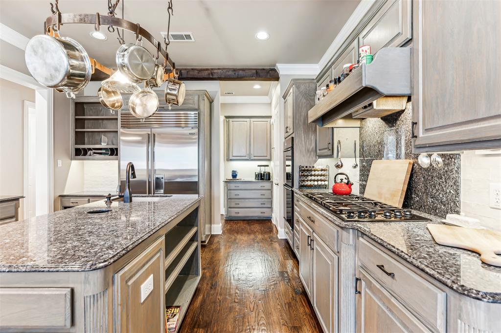1815 West Forest Grove Road Lucas, TX 75002 - Photo 20 of 40 Kitchen with visible vents, open shelves, appliances with stainless steel finishes, under cabinet range hood, and crown molding