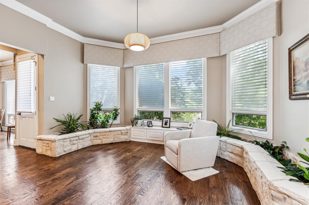1815 West Forest Grove Road Lucas, TX 75002 - Photo 22 of 40 Living area with crown molding and dark wood-style flooring