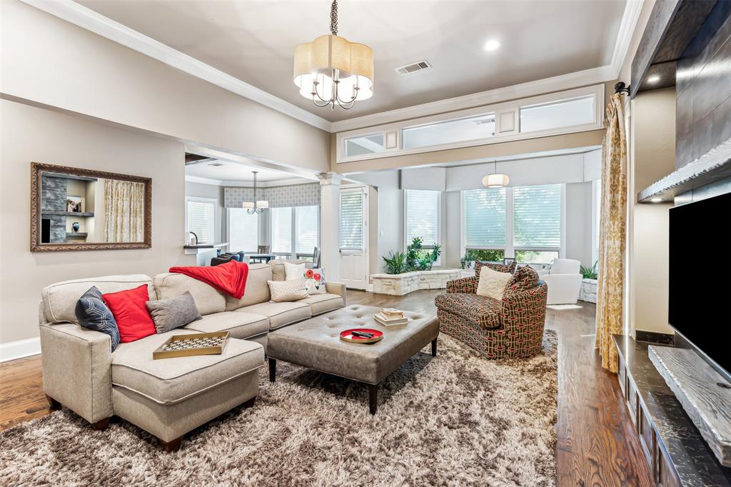 1815 West Forest Grove Road Lucas, TX 75002 - Photo 23 of 40 Living room with visible vents, an inviting chandelier, and ornamental molding
